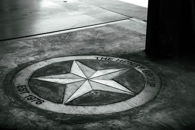 The Henry Group emblem set into the workshop floor