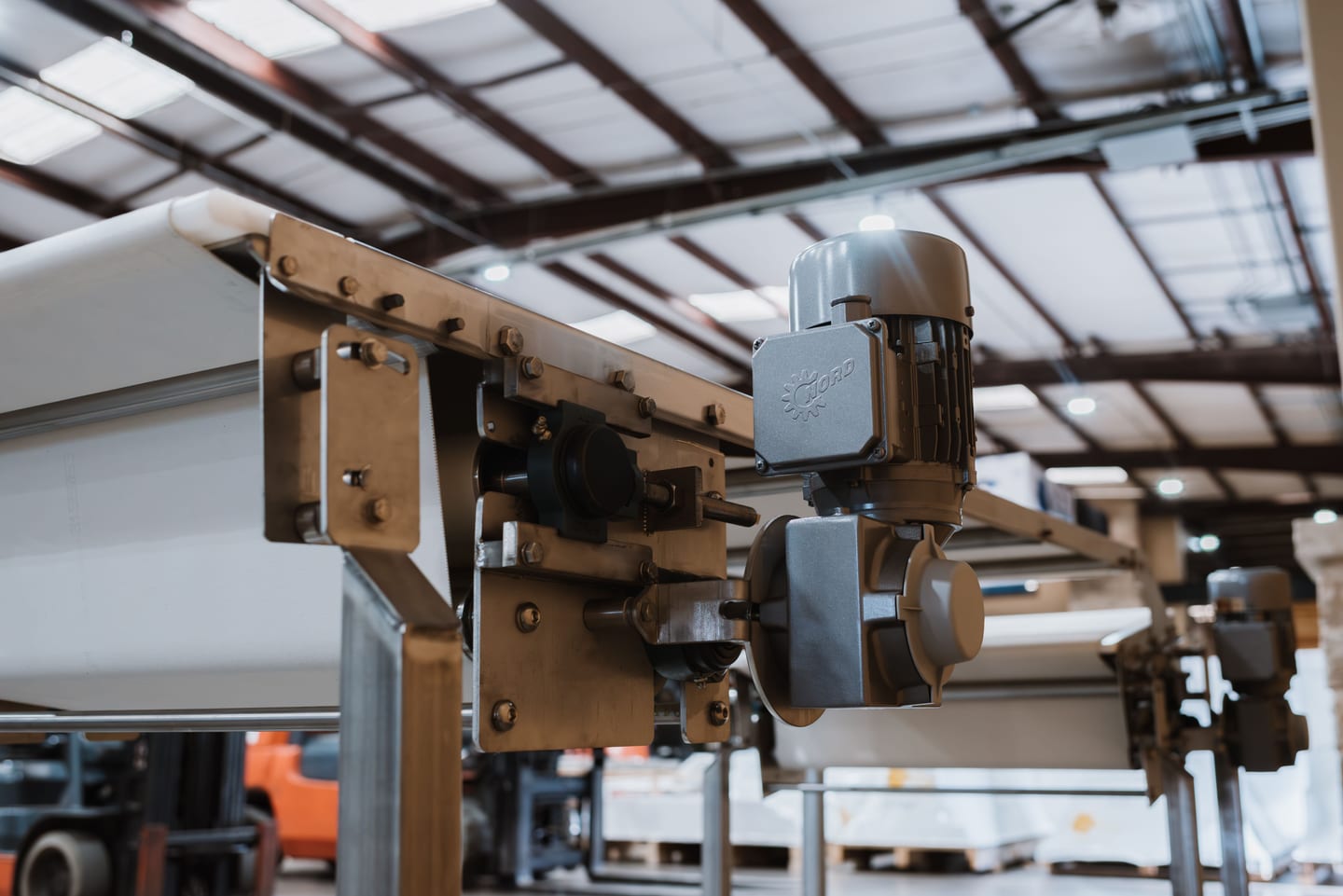 Motor and drive assembly on a stainless dough conveyor