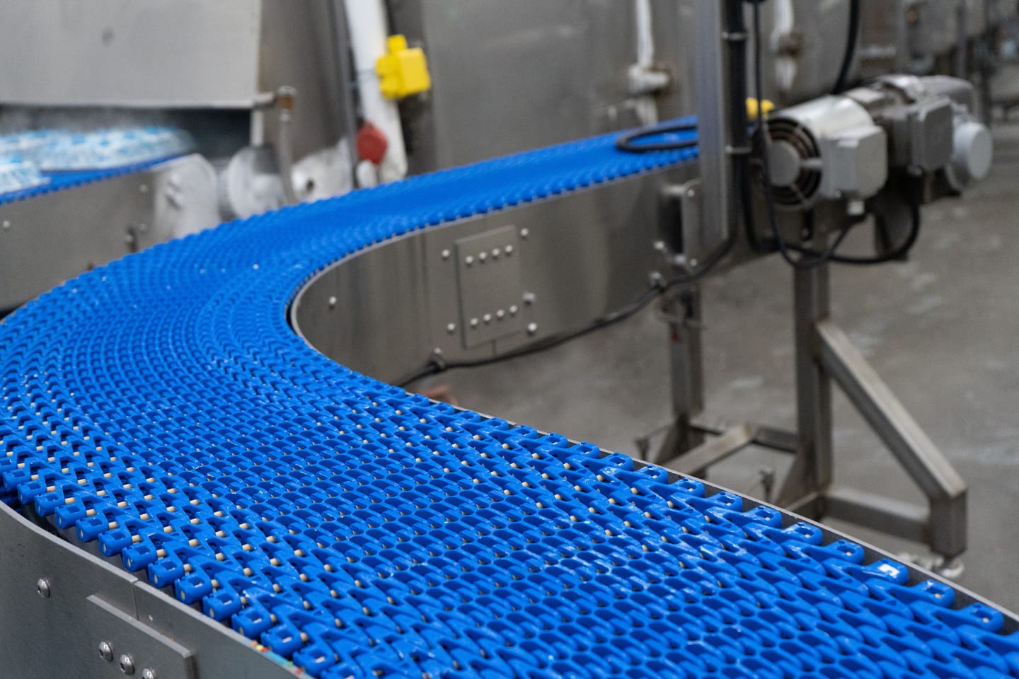 Blue curved conveyor belt and stainless steel frame
