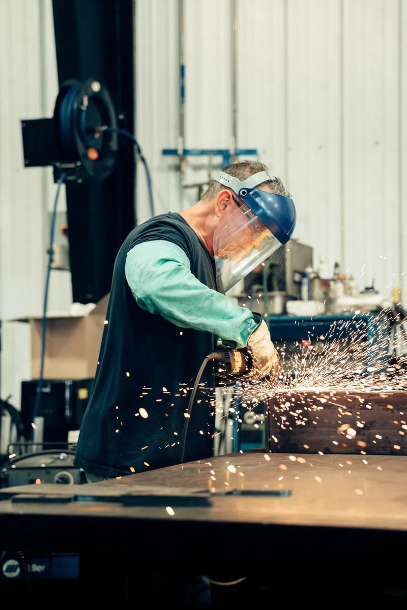 Sparks from finishing a metal part with a handheld tool
