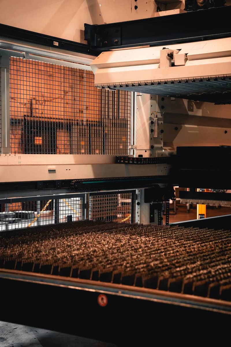 Close view of the flat-sheet laser bed beneath the sheet handling system