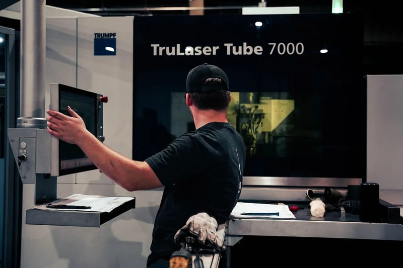 Operator using the tube laser control panel