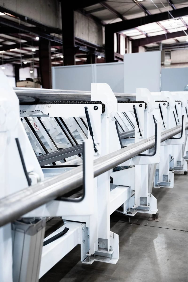 Round metal tubes resting on the tube laser loading supports
