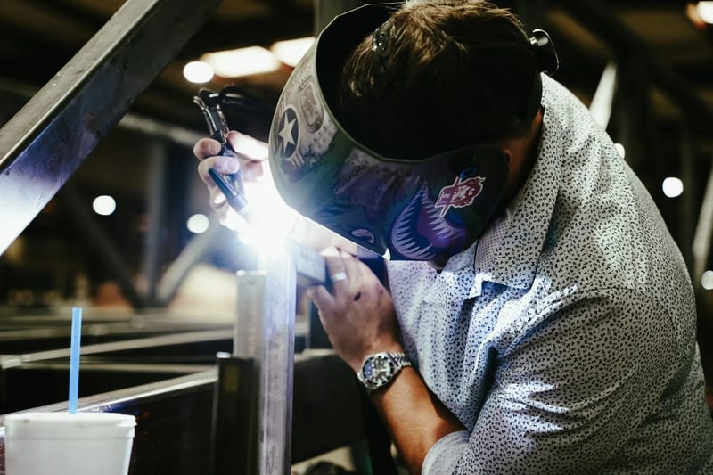 Close view of a welder joining a metal assembly