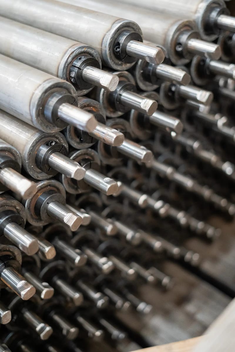 Stacked metal conveyor rollers with exposed shaft ends