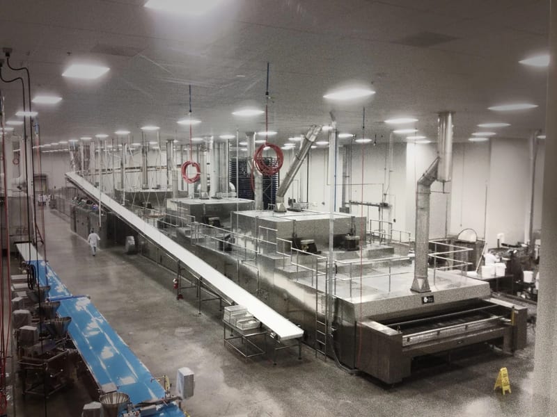 Wide view of an installed industrial oven and adjoining production equipment