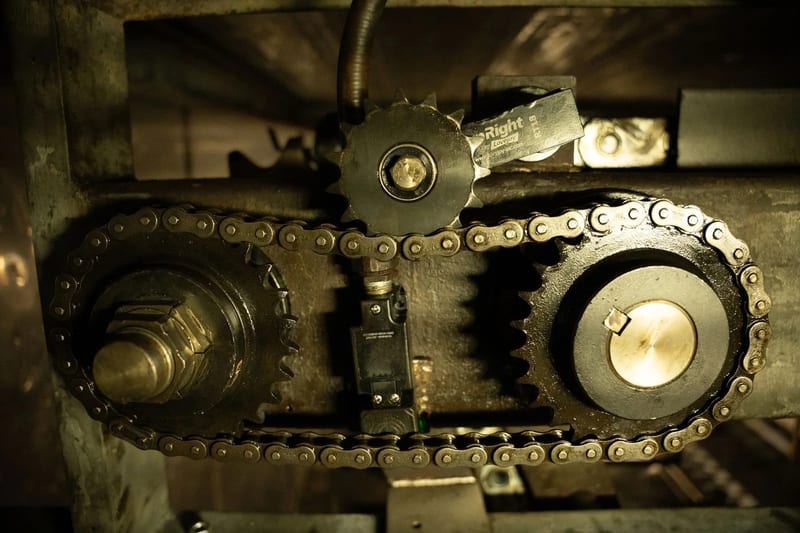 Close view of chain and sprockets in an oven drive assembly