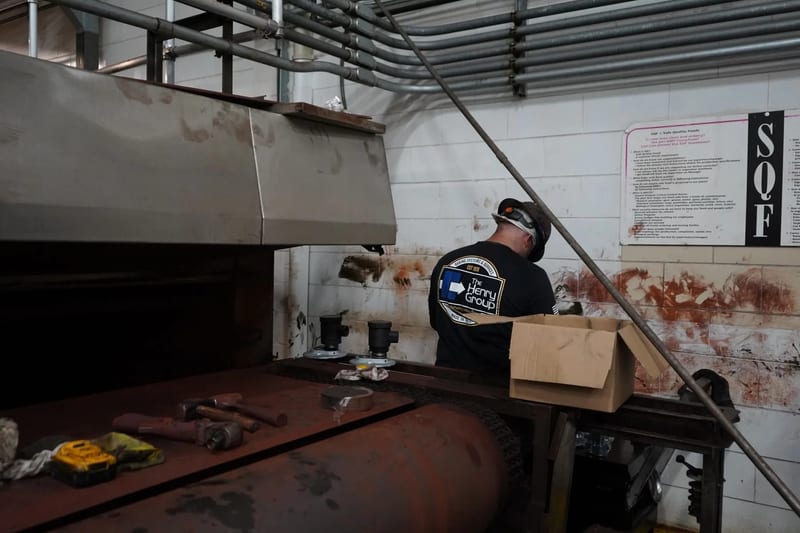 THG technician working beside an open oven assembly