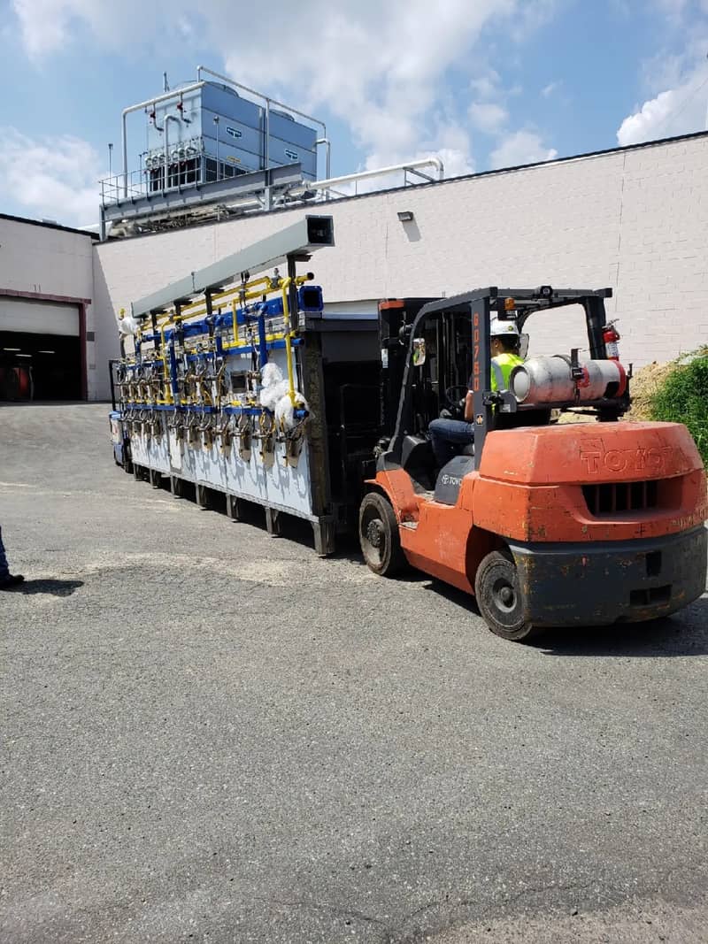 Forklift positioning an oven module