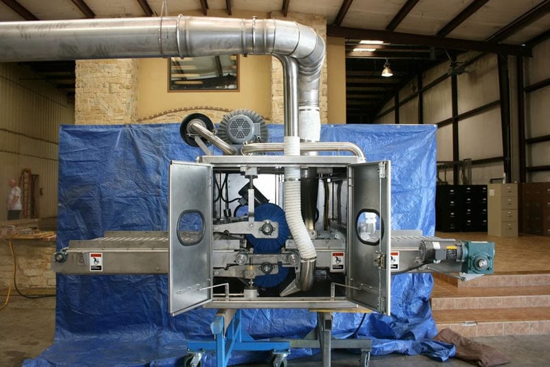 Peel-board cleaner with brushes, drive and extraction duct