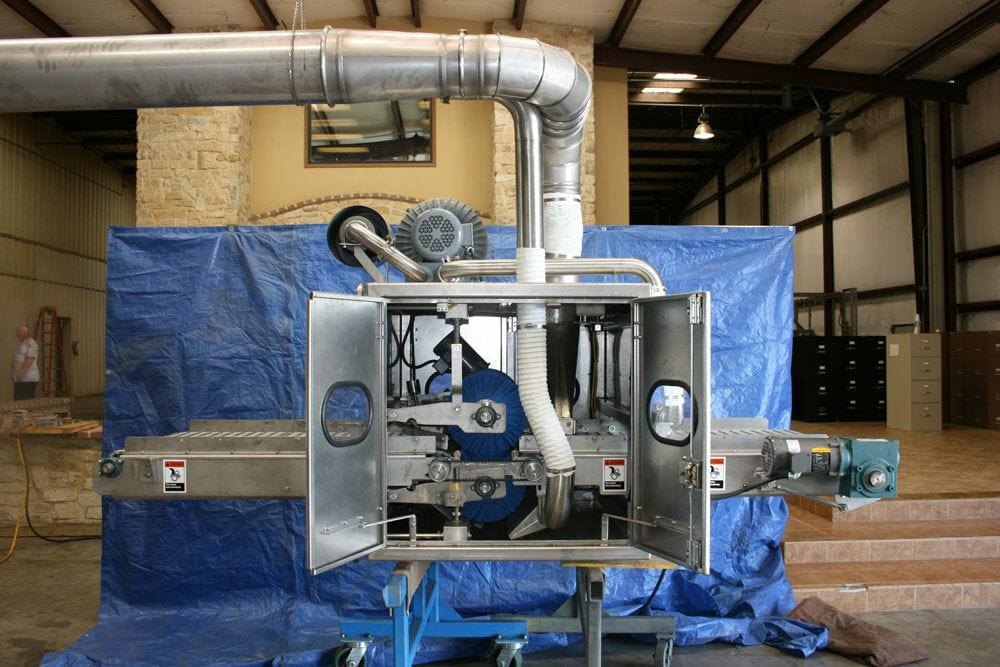 Peel-board cleaner with brushes, drive and extraction duct