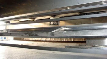 Product carriers in a traveling-tray cooler