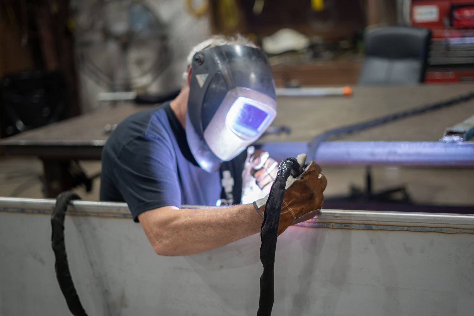 Fabricator welding a stainless steel assembly in the workshop